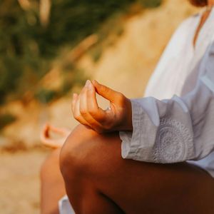 Close-up of hands in a yoga mudra position.
