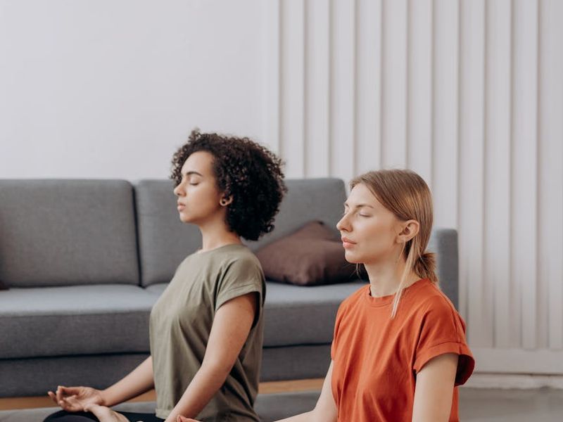 Person practicing yoga in a calm, minimalist room.
